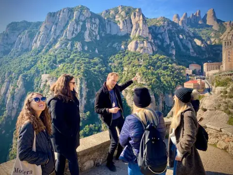 Guests and their guide at a viewpoint over the Montserrat mountains