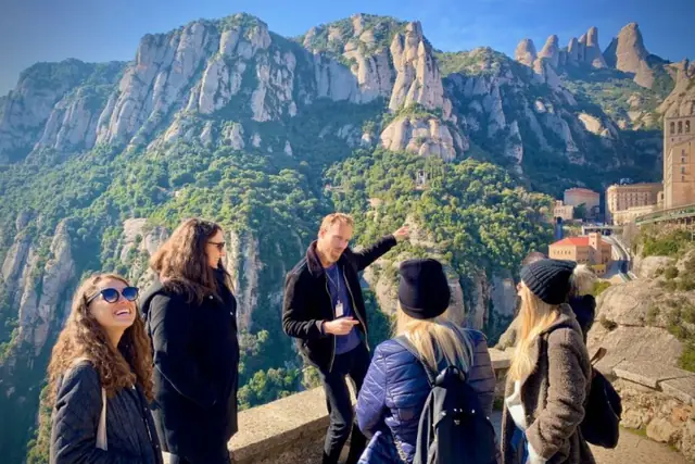 Guests and their guide at a viewpoint over the Montserrat mountains